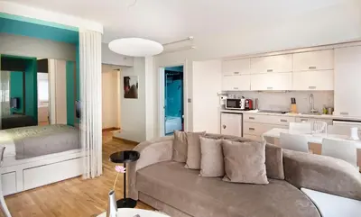 a living room with a couch and a kitchen at Nuru Ziya Residences in Istanbul