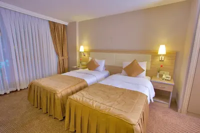 a hotel room with two beds and a window at Laleli Emin Old City Hotel in Istanbul