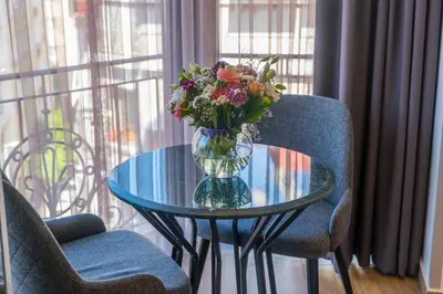 a glass table with a vase of flowers on it at La Wisteria Boutique Hotel Istanbul in Istanbul