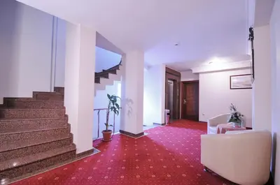 a hallway with stairs and a couch and a chair at Grand Eyuboglu Hotel in Istanbul