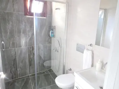 a bathroom with a shower and a toilet and a sink at Istanberry - Paradise Apartments in Istanbul
