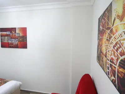 a white room with a painting on the wall at Istanberry - Paradise Apartments in Istanbul