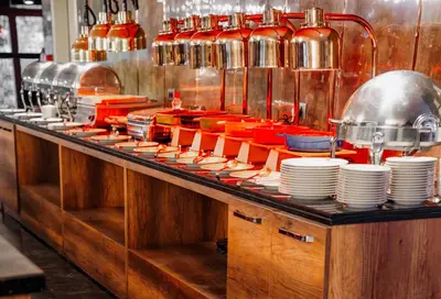 a kitchen with a counter with plates and utensils at Vespia Hotel in Istanbul