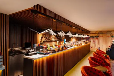 a restaurant with red chairs and a counter with food at Vespia Hotel in Istanbul