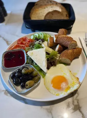a plate of food with an egg and bread at 12 rooms hotel in Köseilyas