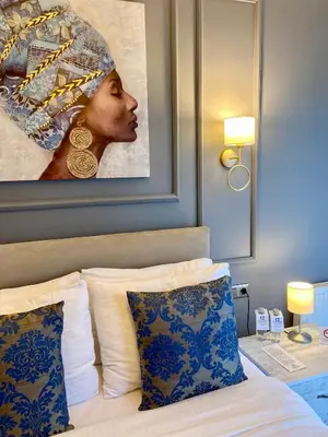 a bedroom with a painting above a bed with pillows at 12 rooms hotel in Köseilyas