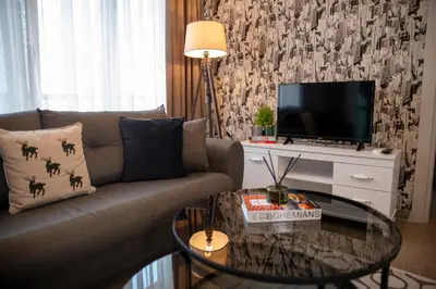 a living room with a couch and a tv at 12 rooms hotel in Köseilyas