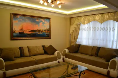 a living room with two couches and a painting at Blue Istanbul Hotel in Istanbul