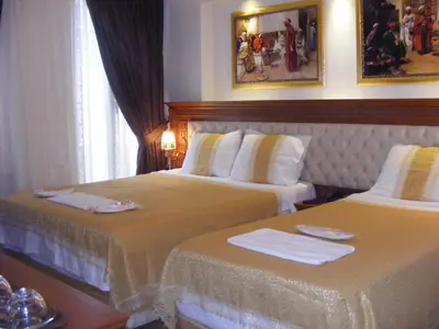 a hotel room with two beds with towels on them at Blue Istanbul Hotel in Istanbul