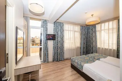 a hotel room with a bed and a window at Tugra Hotel in Istanbul
