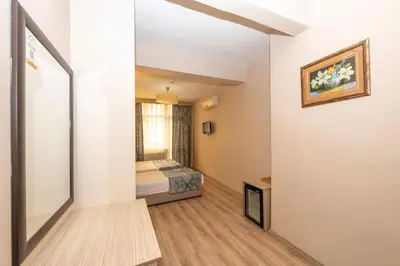 a small room with a bed and a window at Tugra Hotel in Istanbul