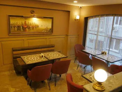 a restaurant with tables and chairs and a painting on the wall at Endless Comfort Hotel Taksim in Istanbul