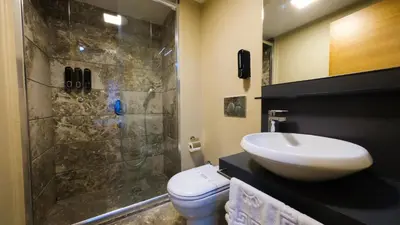 a bathroom with a toilet and a sink and a shower at Endless Comfort Hotel Taksim in Istanbul