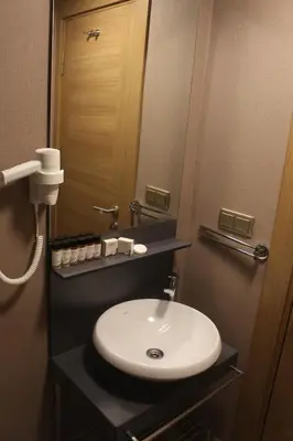 a bathroom with a white sink and a mirror at Endless Comfort Hotel Taksim in Istanbul