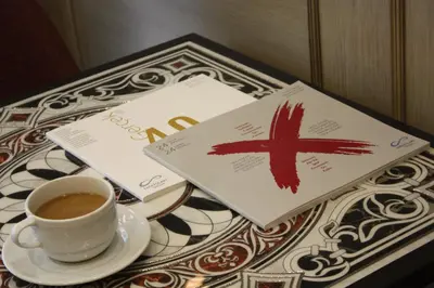 a cup of coffee and a book on a table at Endless Comfort Hotel Taksim in Istanbul