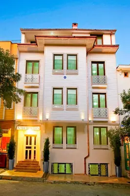 a white building with windows on a street at Azade Suites in Istanbul