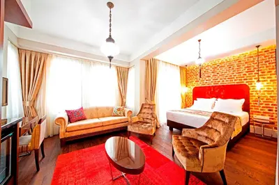 a bedroom with a bed and a brick wall at Azade Suites in Istanbul
