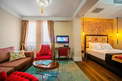 a hotel room with a bed and a couch at Azade Suites in Istanbul