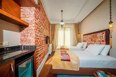 a hotel room with a bed and a brick wall at Azade Suites in Istanbul