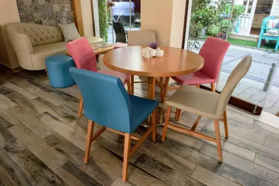 a dining room with a wooden table and chairs at Tayahatun Hotel in Istanbul