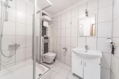 a bathroom with a shower toilet and a sink at Tayahatun Hotel in Istanbul