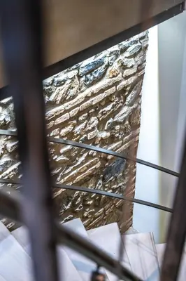a reflection of a stone wall in a window at West Pera Hotel in Istanbul