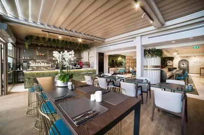 a restaurant with tables and chairs and a bar at Vogue Hotel Supreme Istanbul in Istanbul