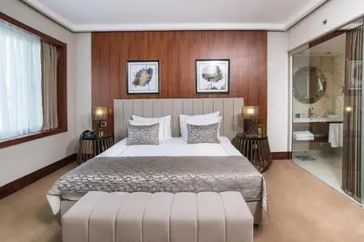 a bedroom with a large bed and a mirror at Vogue Hotel Supreme Istanbul in Istanbul