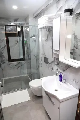 a bathroom with a shower and a sink and a toilet at Ramparts Hotel in Istanbul