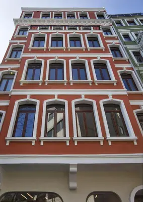 a tall red building with many windows at Juno Hotel Taksim in Istanbul