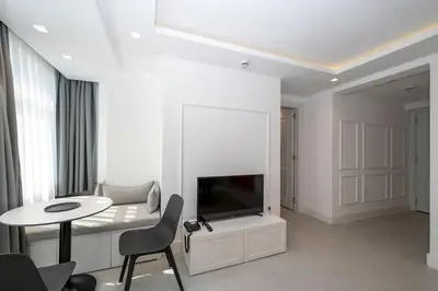 a living room with a tv and a table at Juno Hotel Taksim in Istanbul