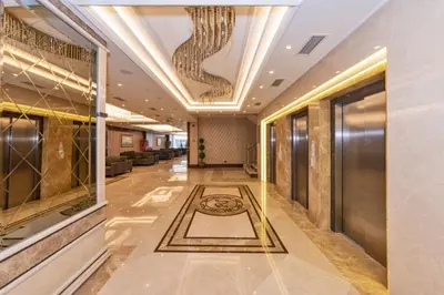 a lobby of a hotel with a chandelier at Piya Sport Hotel in Istanbul