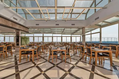 a dining room with tables and chairs and windows at Piya Sport Hotel in Istanbul