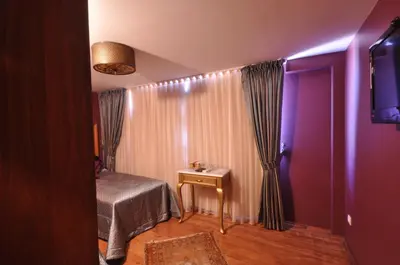 a room with a bed and a table in a room at Merial Hotel Sultanahmet in Istanbul