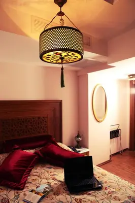 a bedroom with a bed with a laptop on it at Merial Hotel Sultanahmet in Istanbul