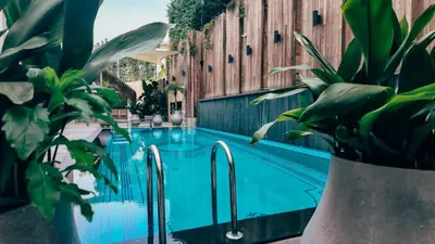 a swimming pool with plants next to a building at Dosso Dossi Hotels & SPA Golden Horn in Istanbul
