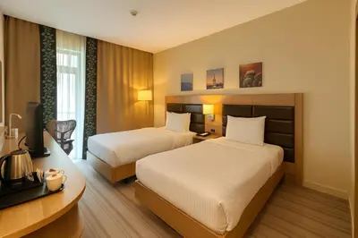 a hotel room with two beds and a desk at Dosso Dossi Hotels & SPA Golden Horn in Istanbul