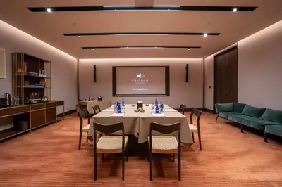 a conference room with a table and chairs and a screen at Glens Palas Istanbul Nisantasi in Istanbul