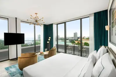a hotel room with a bed and large windows at Glens Palas Istanbul Nisantasi in Istanbul
