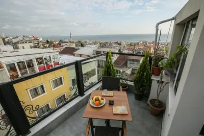a balcony with a table with a bowl of fruit on it at Artika Hotel in Istanbul