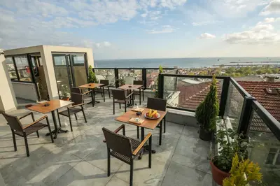 a patio with tables and chairs on a balcony at Artika Hotel in Istanbul