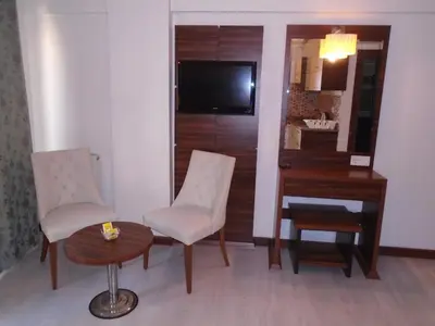 a room with a desk and two chairs and a table at City House in Istanbul