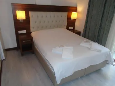 a bedroom with a white bed with two towels on it at City House in Istanbul