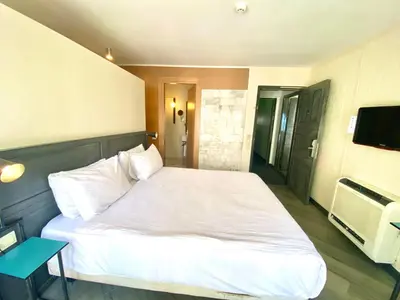 a bedroom with a white bed and a television at Faros Hotel Taksim-Special Category in Istanbul