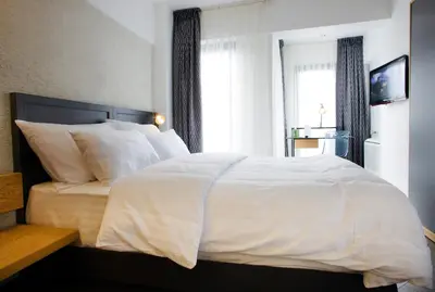 a bedroom with a white bed and a window at Faros Hotel Taksim-Special Category in Istanbul