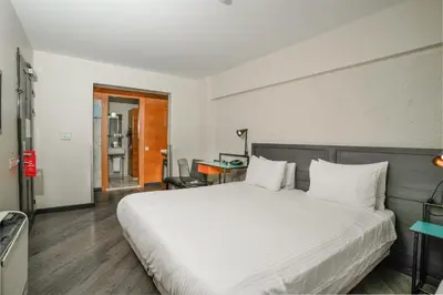 a bedroom with a large white bed and a desk at Faros Hotel Taksim-Special Category in Istanbul