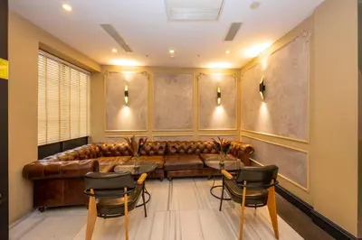 a living room with a leather couch and chairs at Premist Hotels Taksim in Istanbul
