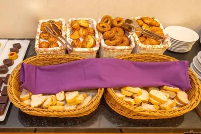 a table topped with baskets of bread and pastries at Premist Hotels Taksim in Istanbul