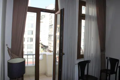 a room with a window and a table and chairs at Taksim House Suites in Istanbul