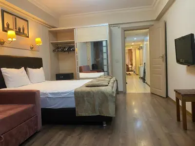 a hotel room with a bed and a television at Taksim House Suites in Istanbul